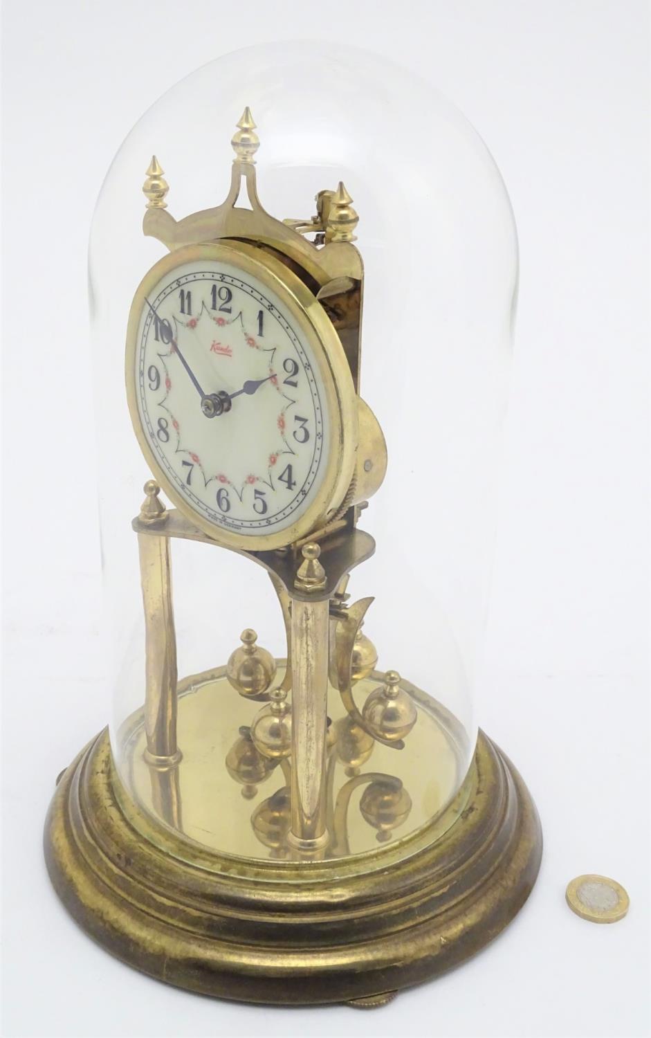 A mid 20thC 'Kundo' anniversary clock with a glass dome above a brass frame. 12" high. Please Note - - Image 7 of 13