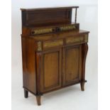 A 19thC rosewood chiffonier with a panelled up stand supported by two turned columns. Having two