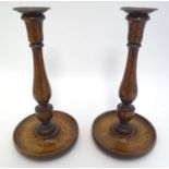 Treen: A pair of 19thC oak candlesticks with circular bases. Approx. 10 1/2" high. Please Note -