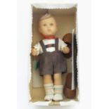 A large M.J. Hummel Goebel vinyl figure of a young boy in Bavarian alpine dress with a painted