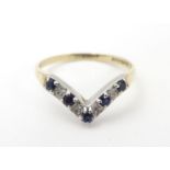 A 9ct gold ring set with diamonds and blue spinel in a wishbone setting. Ring size approx O Please