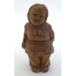 A 19thC folk art carved wooden figure modelled as a Russian woman. Approx. 3 1/4" high. Please