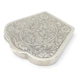 A white metal compact with engraved decoration. Approx. 3 1/4" wide Please Note - we do not make