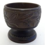 A late 19th / early 20thC treen table salt with foliate decoration. Approx. 2" high Please Note - we