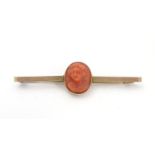 A 9ct gold bar brooch set with 19thC carved coral cameo 2" wide overall. Please Note - we do not