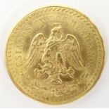 A 1943 gold 50 pesos coin commemorating Mexico's 100th anniversary of independence from Spain. The