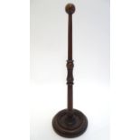 A 19thC treen stand with a circular base and spherical finial, possibly a wig stand. Approx. 14 3/4"