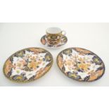 A Royal Crown Derby tea cup and saucer in the Imari palette with floral and scrolling foliate
