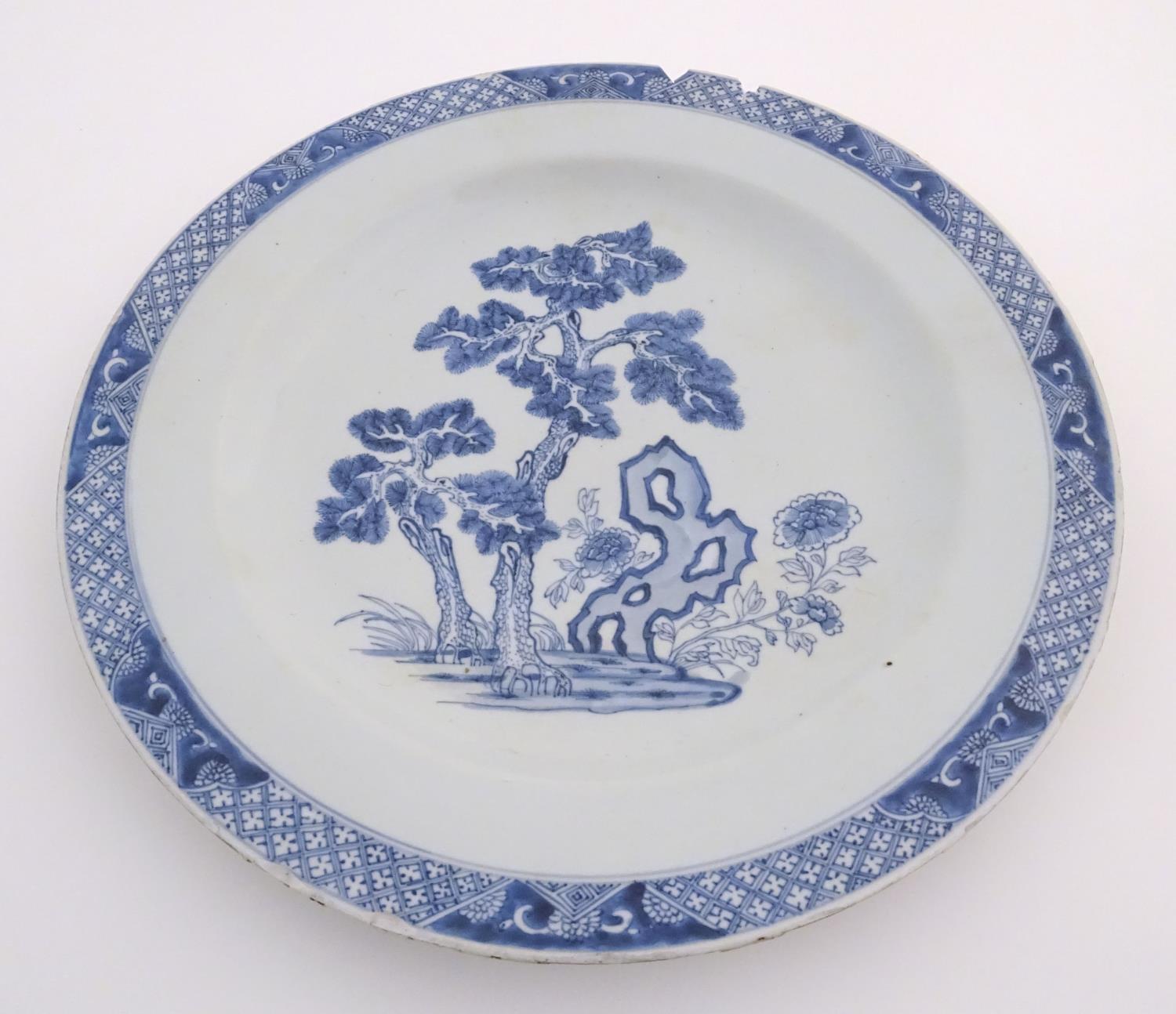 A Chinese blue and white charger decorated with a stylised landscape with trees and flowers, and a - Image 7 of 21