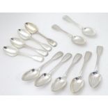 A set of eleven Victorian Fiddle and Thread pattern dessert spoon with engraved armorial to