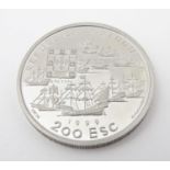 A 1999 200 Escudos palladium coin the obverse depicting 11 boats at anchor, the 9 carracks and 2