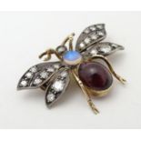 A late 19thC / early 20thC brooch formed as a winged insect , with garnet cabochon and opal body and
