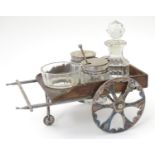 A Victorian glass and silver plate novelty four piece cruet set, the wooden and silver plate stand