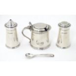 An Art Deco silver three piece cruet set, comprising salt, pepper and mustard pot, hallmarked