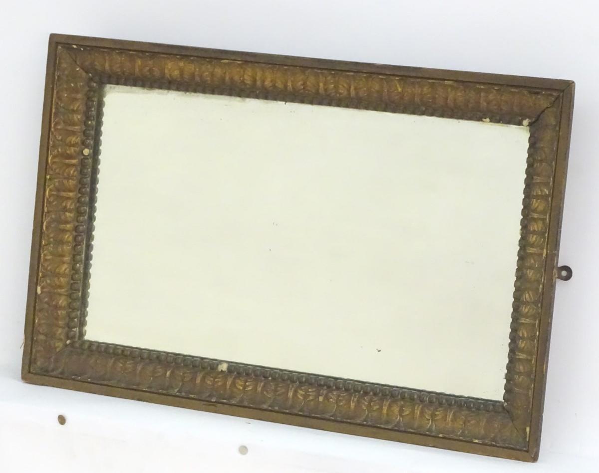 An early / mid 20thC rectangular mirror with a moulded surround and beadwork decoration. 23 1/2"