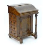 A mid 19thC burr walnut davenport with cross banding and decorative stringing, the top opening to