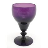 A 19thC amethyst glass wine glass, with knopped stem. 6" tall. Please Note - we do not make