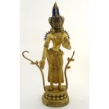 A 20thC gilt metal figure depicting diety Tara in a standing pose, with polychrome highlights,