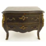 A Victorian leather covered music box formed as a bombe commode with gilt metal mounts. Approx. 9"