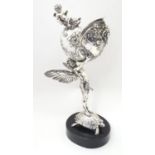 A late 19th / early 20thC silver plate centrepiece / spoon warmer formed as an angel stood upon a