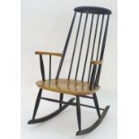 A mid / late 20thC Windsor style rocking chair, with a shaped top rail and turned backrests and