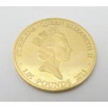 A 2013 gold St Helena 1.05 pound coin, commemorating the 350th anniversary of the Guinea. The