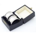 A cased pair of silver napkin rings hallmarked Birmingham 1958 maker Adie Brothers Ltd. Please
