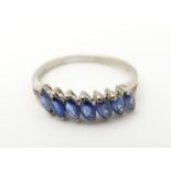 An 18ct white gold ring set with blue topaz? stones. Ring size approx size O. Please Note - we do