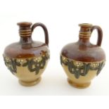 A pair of Royal Doulton miniature salt glaze vases of flagon form with foliate decoration. Impressed