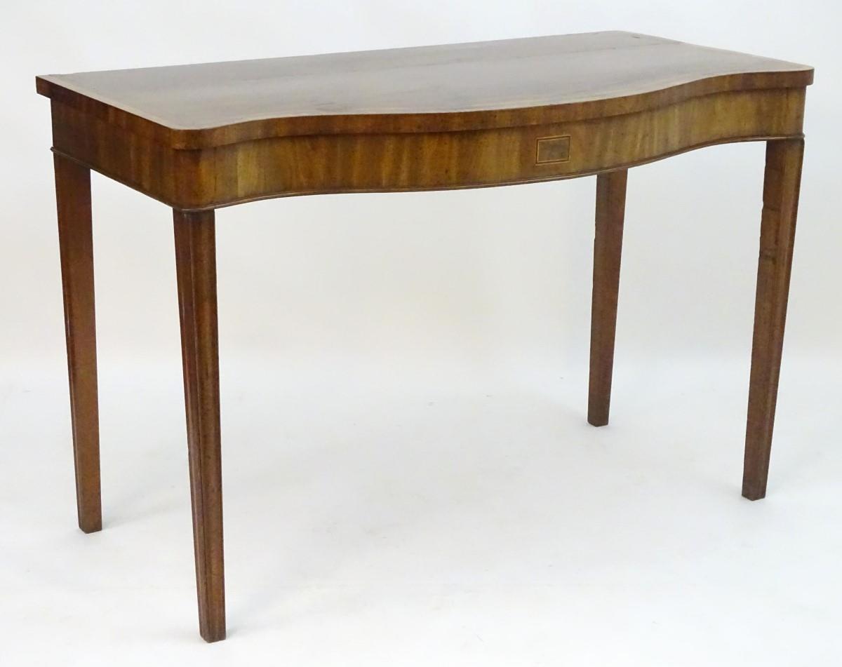 An early 19thC mahogany serving table with a serpentine shaped front, crossbanded top and having - Image 4 of 17
