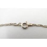 A silver necklace with heart chaped pendant set with pale blue stones. The whole approx 19" long