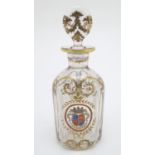 A 19thC glass decanter and stopper, decorated with hand painted marquess armorial and laurel with