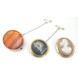 A shall carved cameo in a 9ct gold brooch mount together with a Wedgwood jasper wear roundel