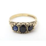 A 9ct gold ring set with blue spinel stones and diamonds. Ring size approx P Please Note - we do not