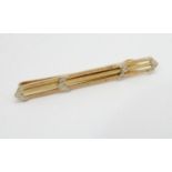 A Continental gold tie clip Marked with Arabic script marks. 2 1/4" wide (5g) Please Note - we do