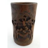A large bamboo brush pot with carved decoration depicting Oriental figures in a landscape with
