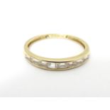 A 14ct gold ring set with white stones. Ring size approx size R. Please Note - we do not make