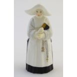 A Royal Worcester figural candle snuffer modelled as a nun. Marked within. Approx. 3 3/4" high