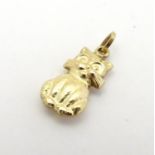 A yellow metal pendant charm formed as a cat. Approx 1/2" long Please Note - we do not make