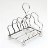 A Victorian silver four division toast rack, hallmarked Sheffield 1893, maker W. W. Harrison & Co.