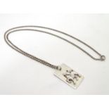 A Hallmarked silver pendant on sterling silver chain, the rectangular pendant with a cast