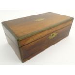 A 19thC writing box, of rosewood and mahogany construction with brass furniture. The lid opening