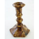 An English 18th / 19thC hexagonal candlestick with a mottled treacle glaze. Approx. 6 1/4" high