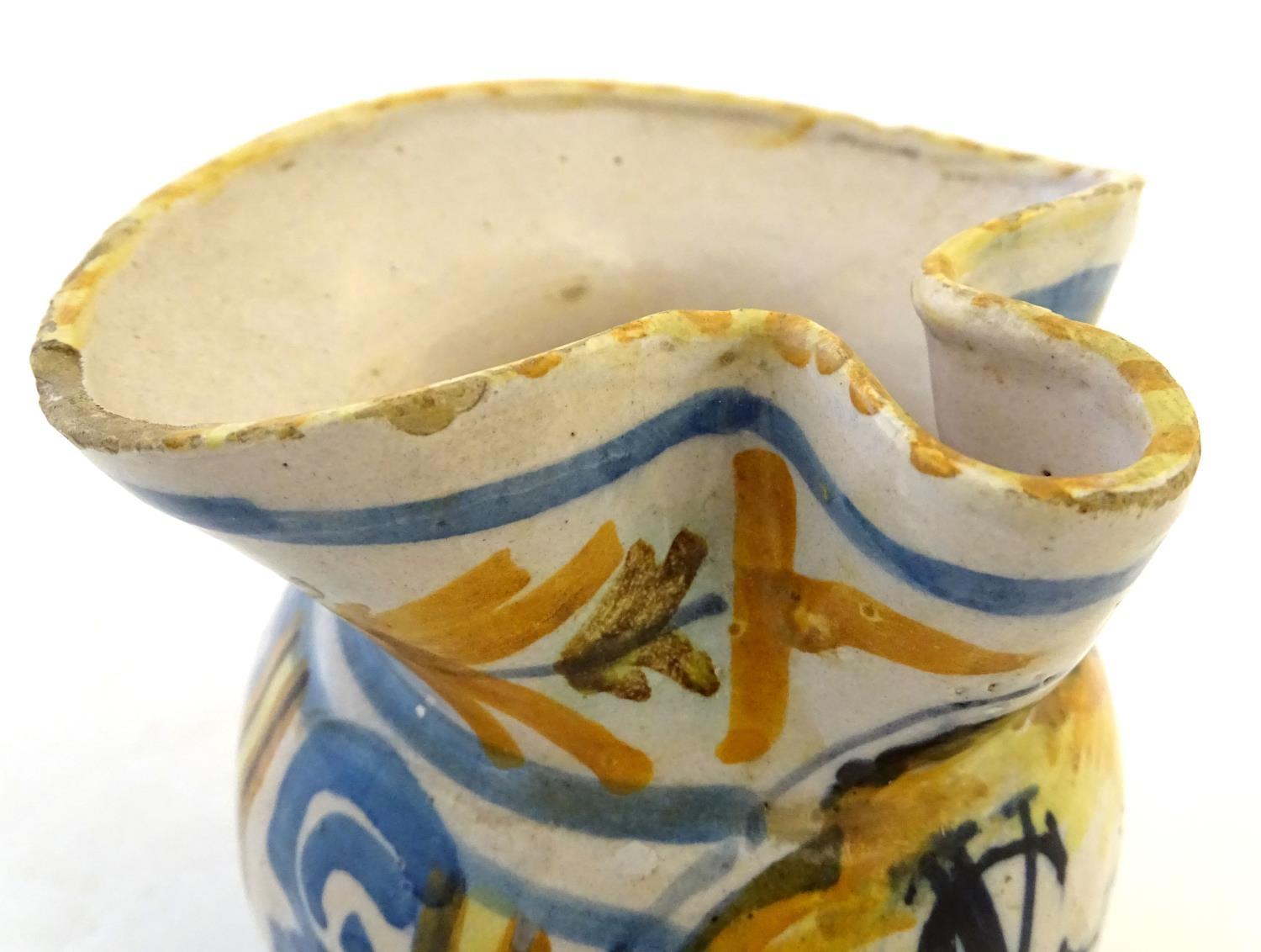 A 19thC Continental faience / tin glaze jug with a pinch spout, decorated with a roundel inscribed - Image 7 of 10