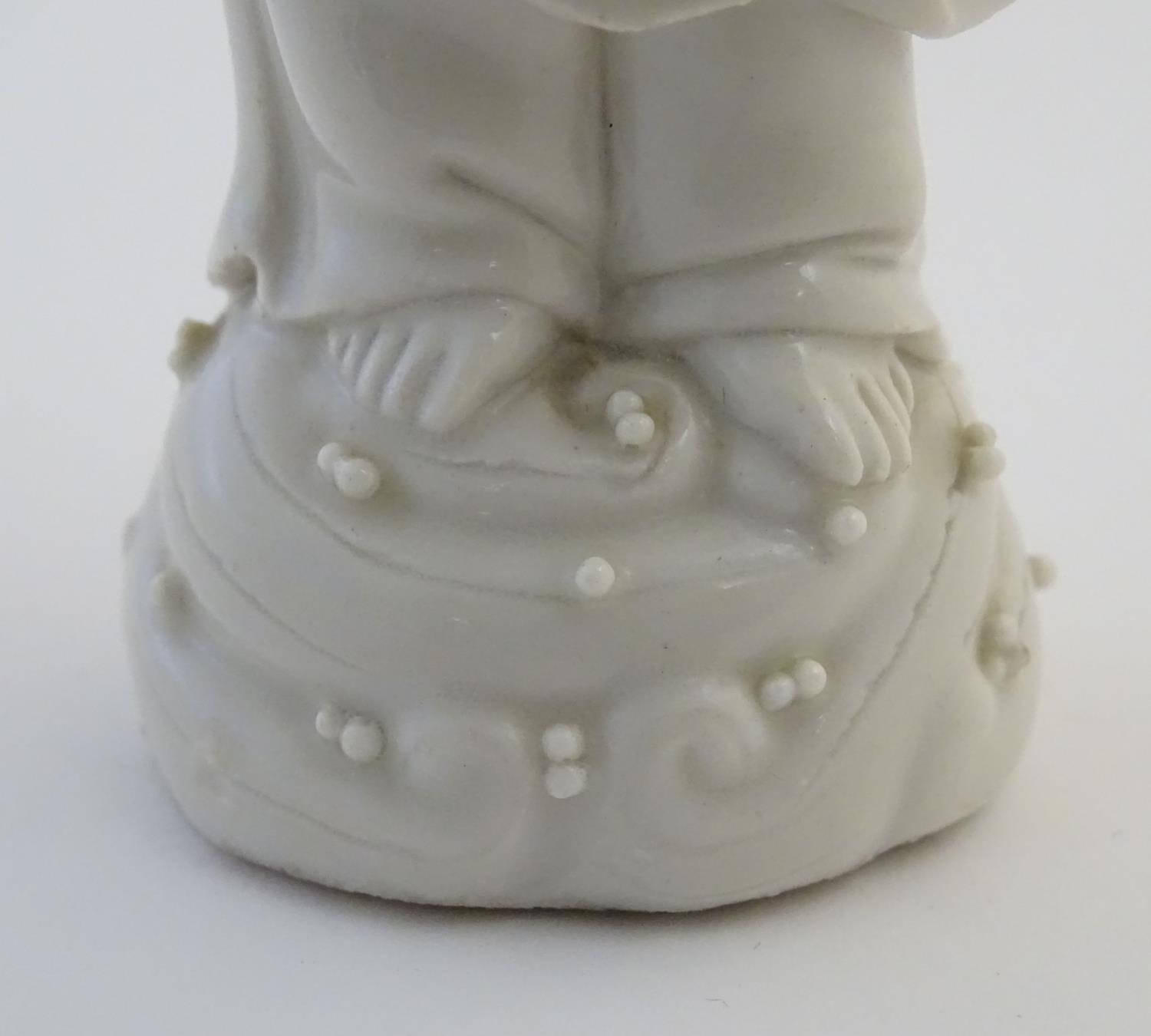 A Chinese blanc de chine depicting the Daoist Immortal figure, Lan Caihe, with a basket of - Image 8 of 9