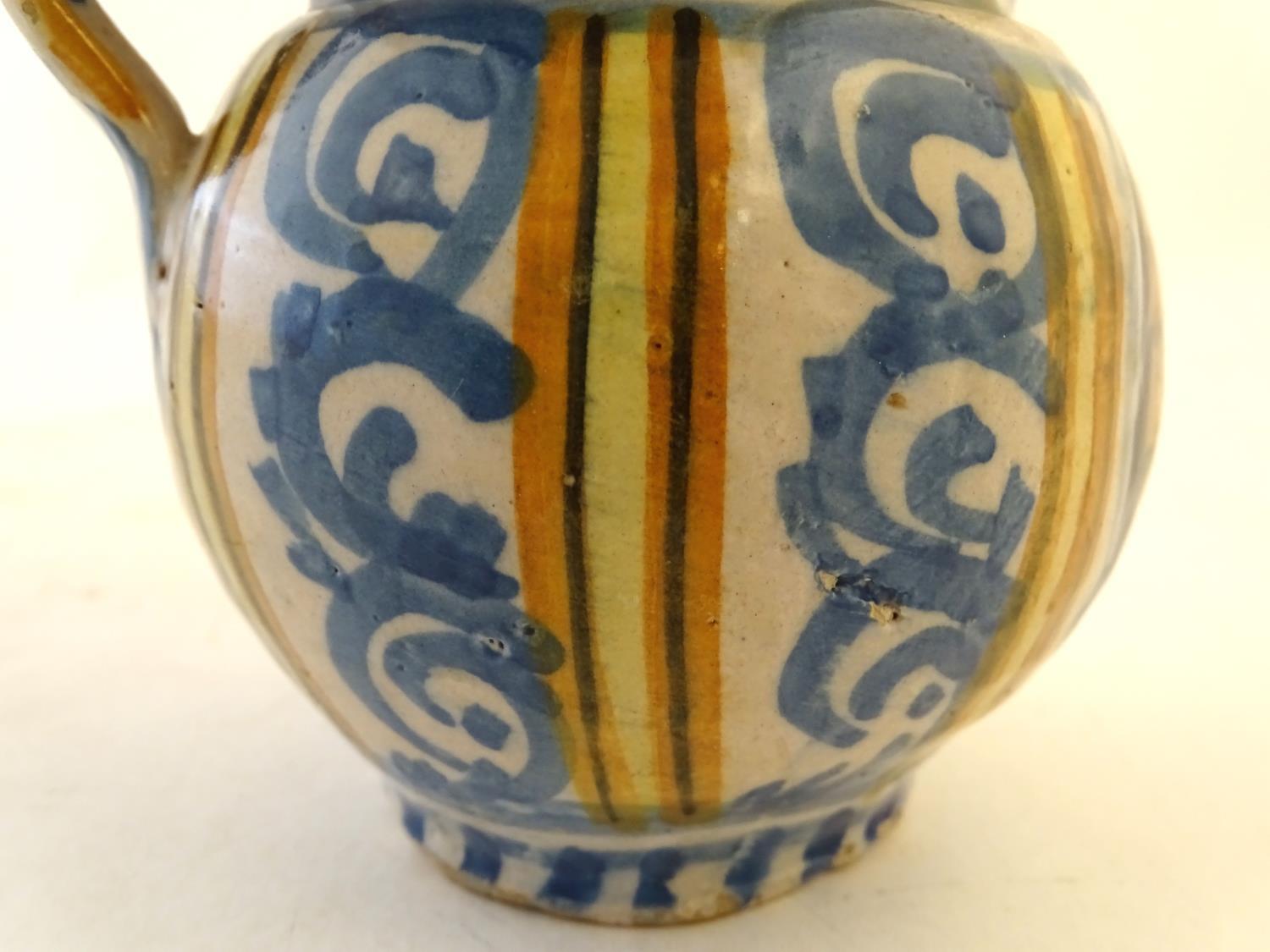 A 19thC Continental faience / tin glaze jug with a pinch spout, decorated with a roundel inscribed - Image 8 of 10