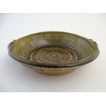 A Roger Cockram studio pottery twin handled bowl. Northcott Pottery mark to side. Approx. 13"
