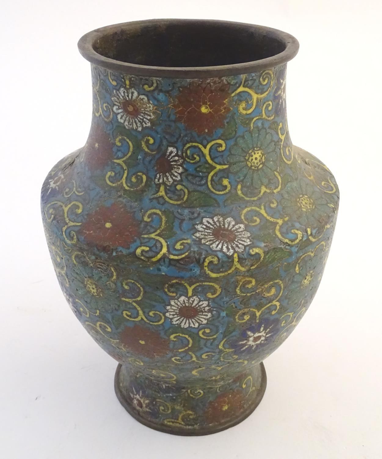 A 19th / 20thC oriental cloisonne enamel vase of baluster form with scrolling floral and foliate