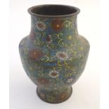 A 19th / 20thC oriental cloisonne enamel vase of baluster form with scrolling floral and foliate