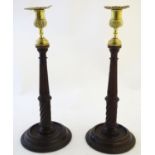 A pair of 20thC oak candlesticks with brass sconces with foliate detail. Approx. 13 1/2" high (2)